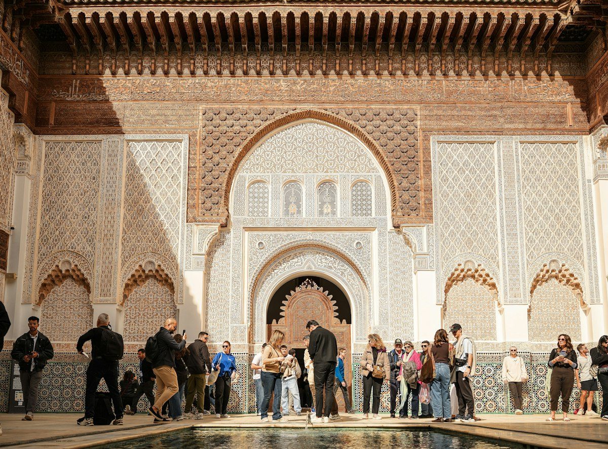A group of travellers gathered in a tiled Moroccan courtyard